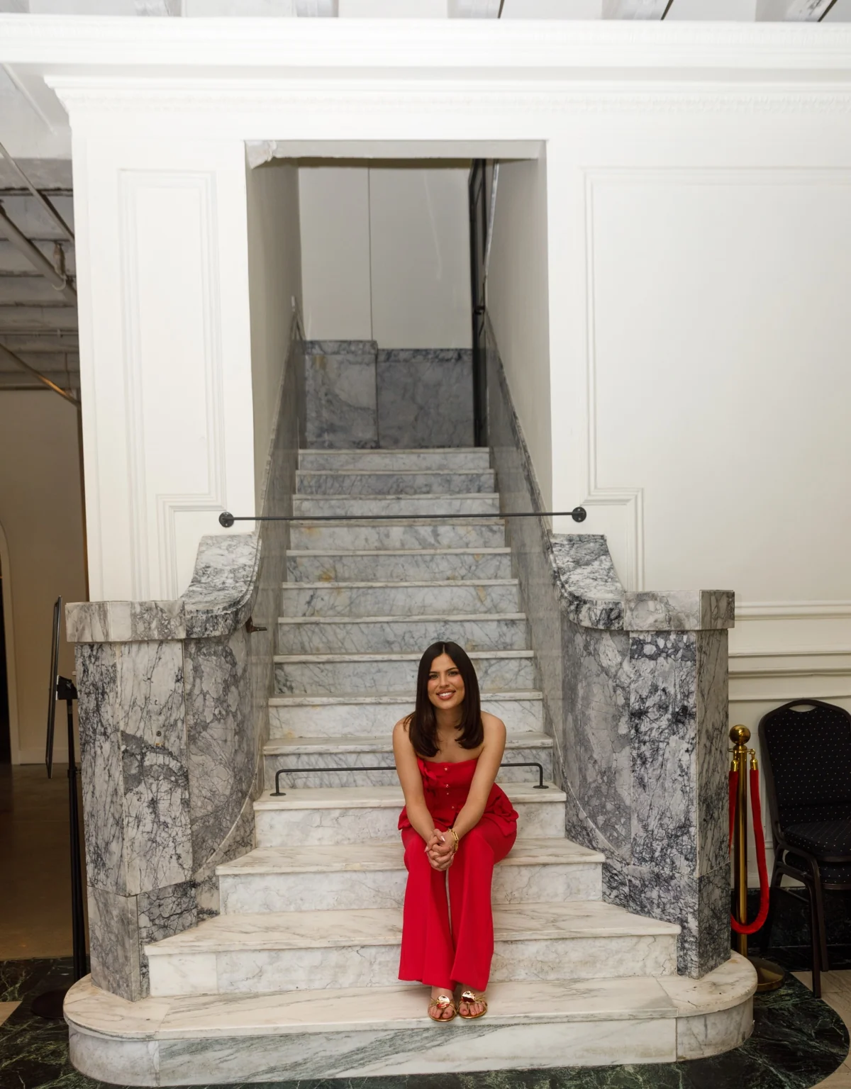Cristina Luckey seated on a marble staircase